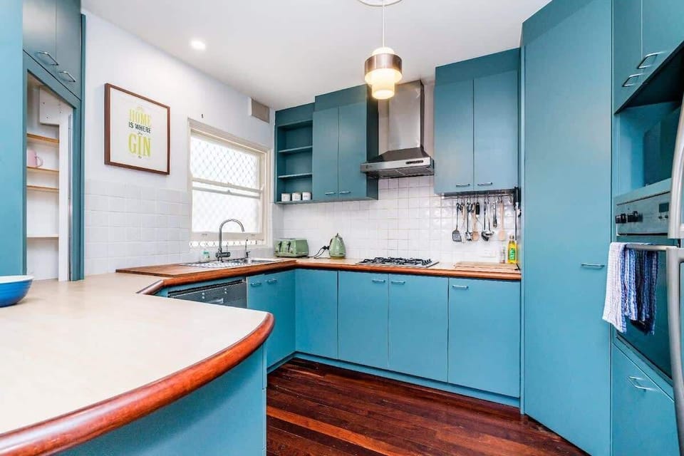 Gather and create in this inviting kitchen, boasting a fresh design with bold blue accents and everything you need for a comfortable stay.