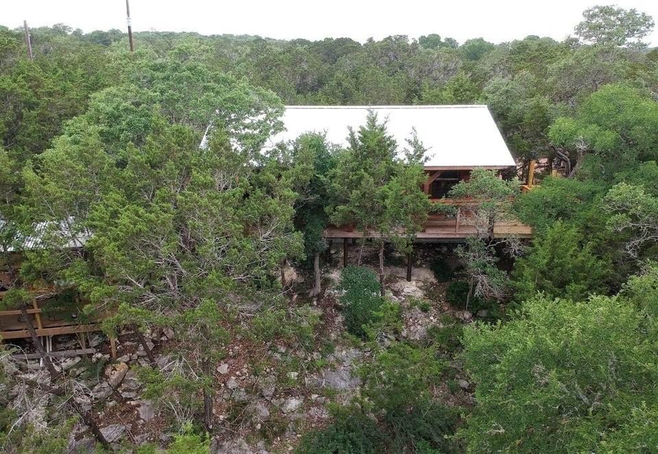 View of the Cabin, Porch, BBQ Station & Lookout from across the Creek Bed.