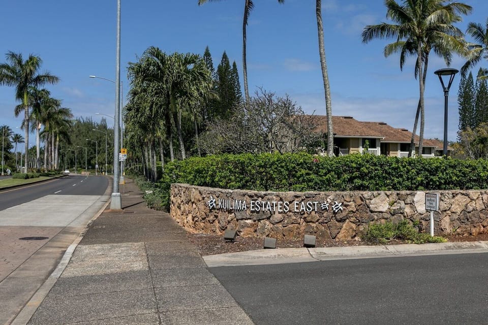 Entrance to the condos with tall palm trees.