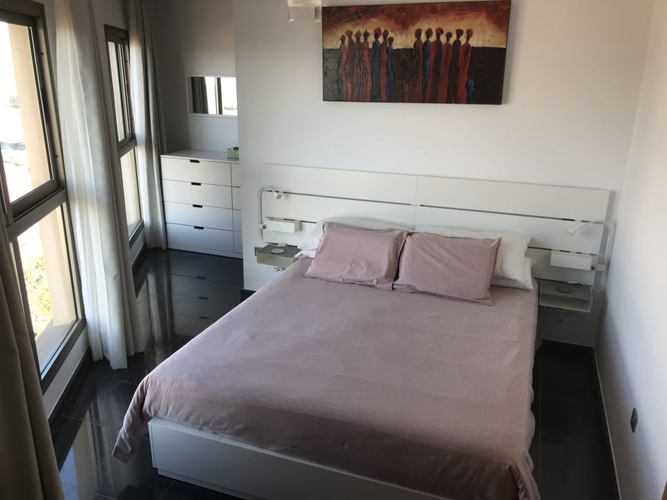 The Queen size bed, with dressing room behind.