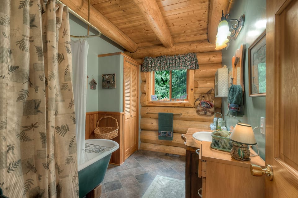 Beside the office, a full bath has a free-standing tub and showerhead along with storage for longer stays.