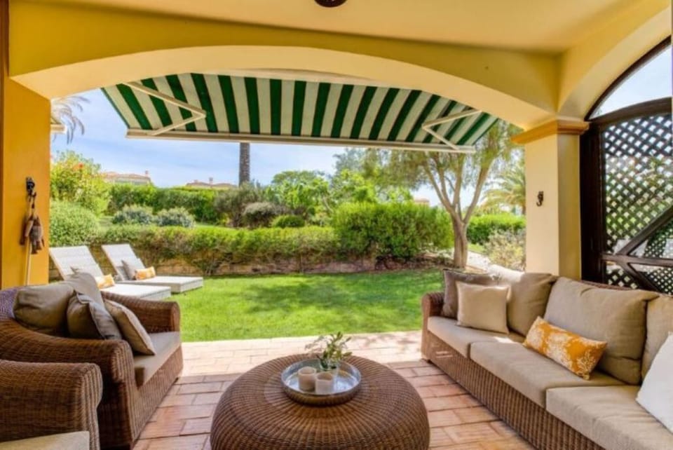 south facing terrace leading from lounge ,with sun shades and private garden 