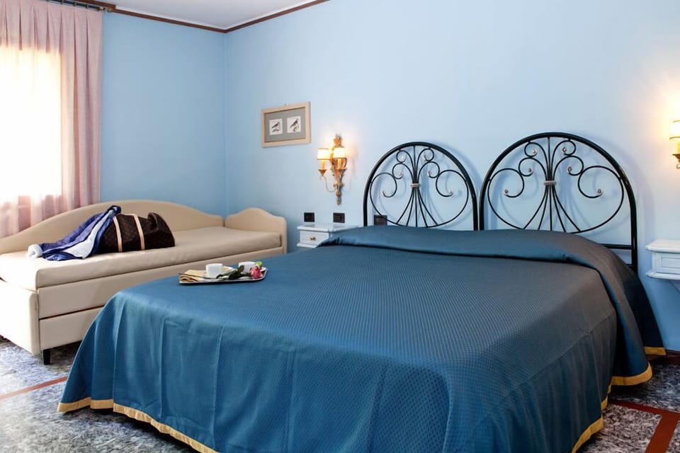 Triple Room | Pillowtop beds, minibar, in-room safe, individually decorated