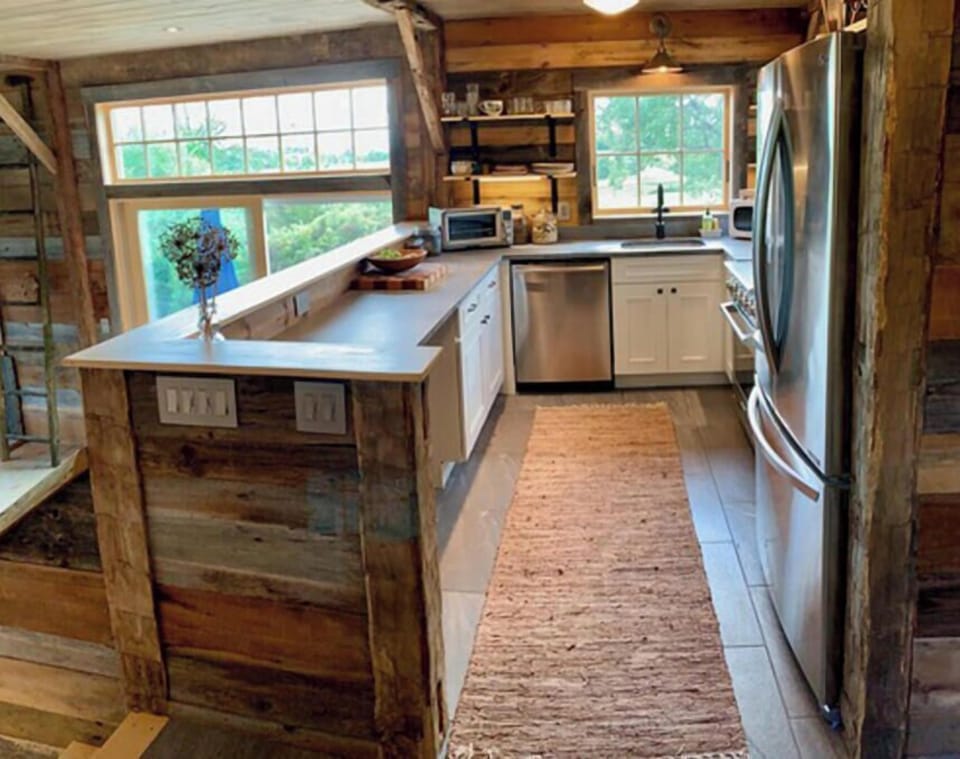 The kitchen looks out to the living room.
