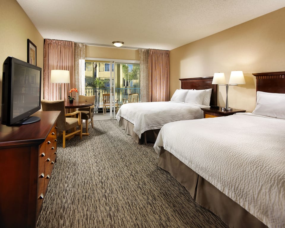 Hypo-allergenic bedding, desk, laptop workspace, blackout drapes