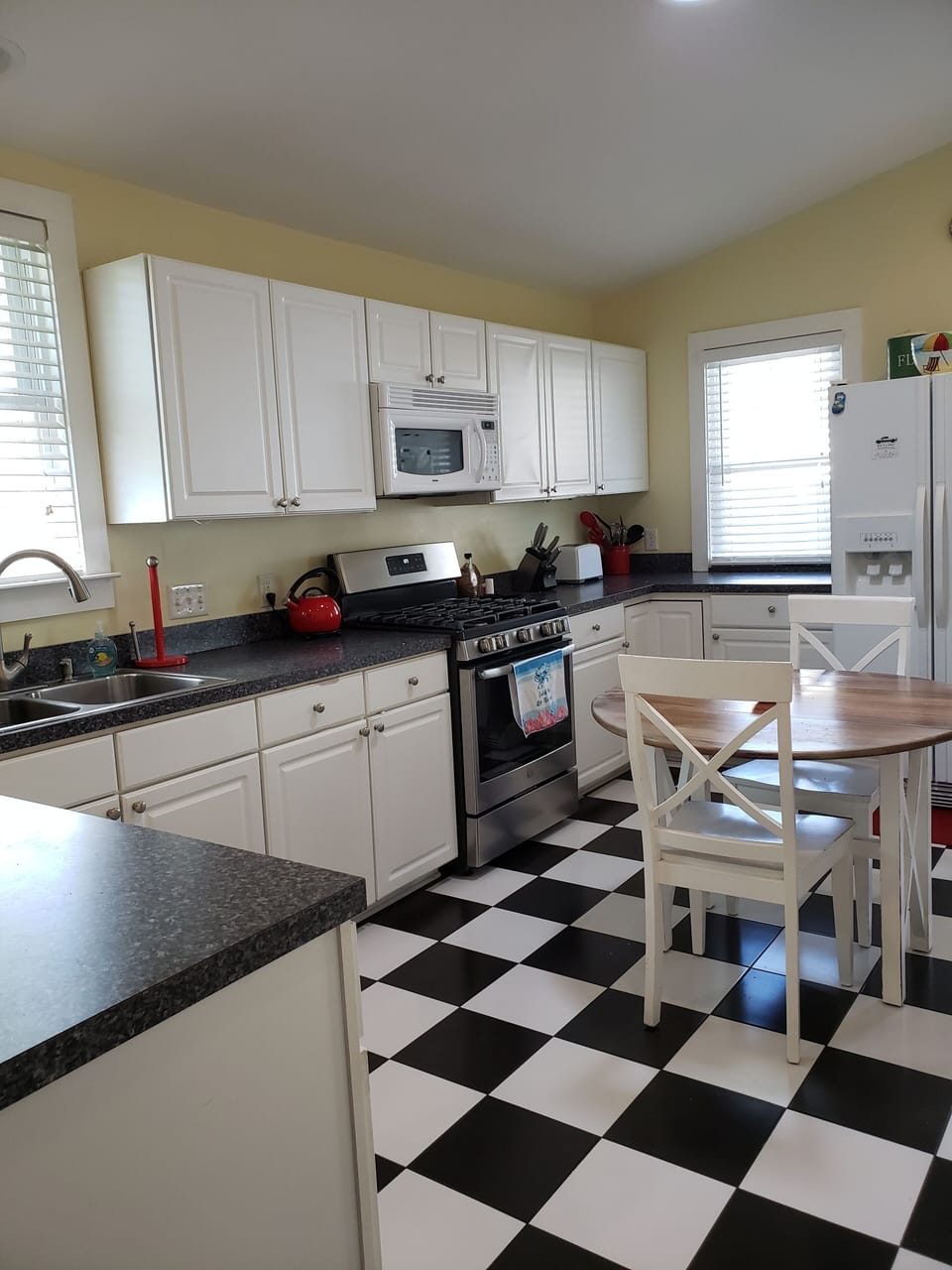Kitchen with new side by side fridge and ice maker.