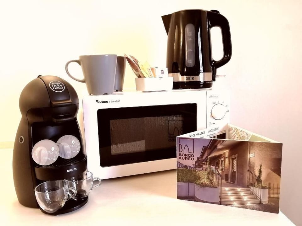 Full-size fridge, stovetop, electric kettle, cookware/dishes/utensils