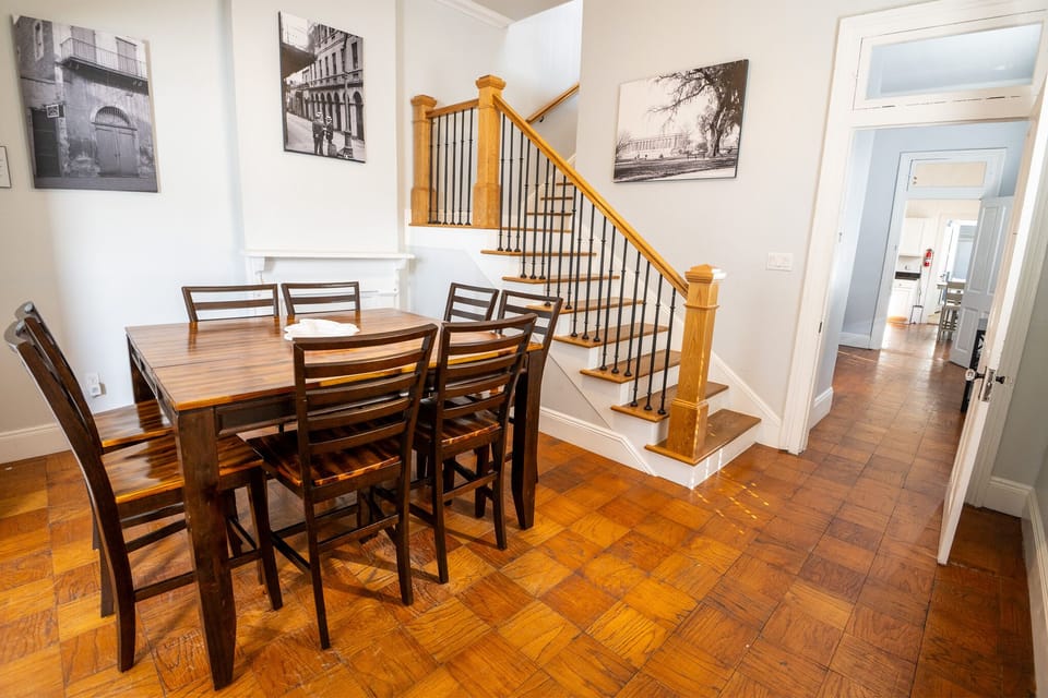The bright dining area features a beautiful wooden table with seating for six.