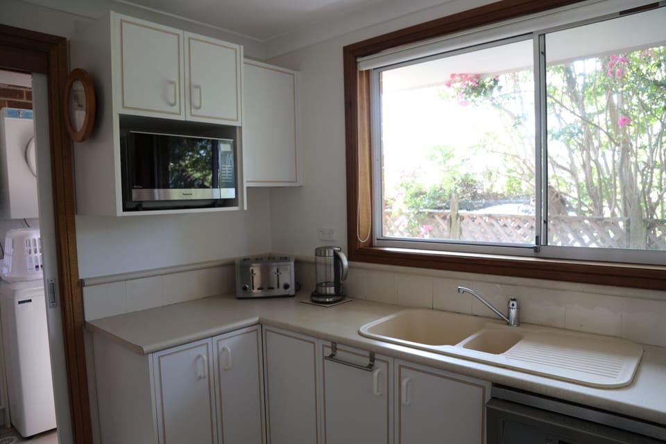 Sunny kitchen with s/s model appliances, including Nespresso Coffee Machine.