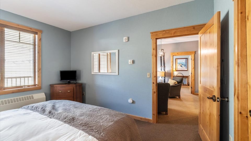 The guest bedroom features a luxury king mattress, HDTV with streaming and cable, large closet, and alpine views.