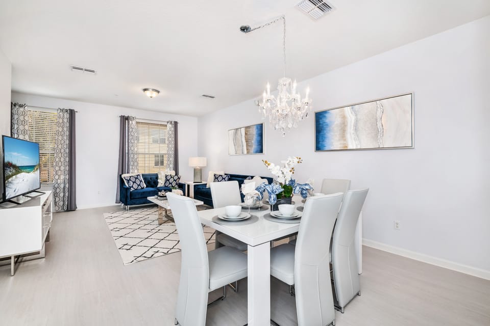 The dining area near the living room  offers a welcoming space for shared meals and cherished conversations, where guests come together to savor delicious flavors and create unforgettable moments amidst the comfort of home.