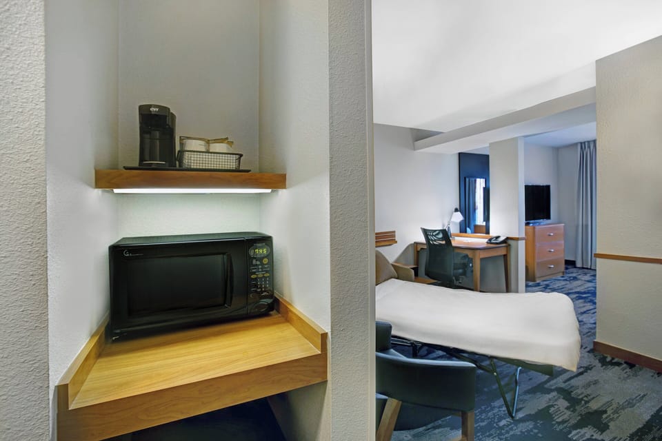 Premium bedding, desk, laptop workspace, blackout drapes