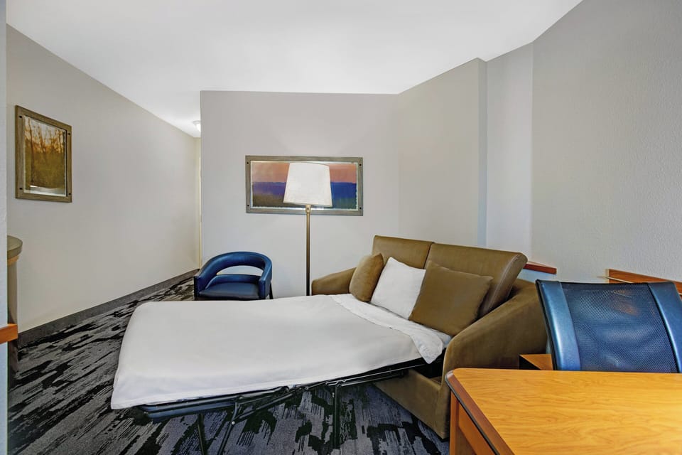 Premium bedding, desk, laptop workspace, blackout drapes