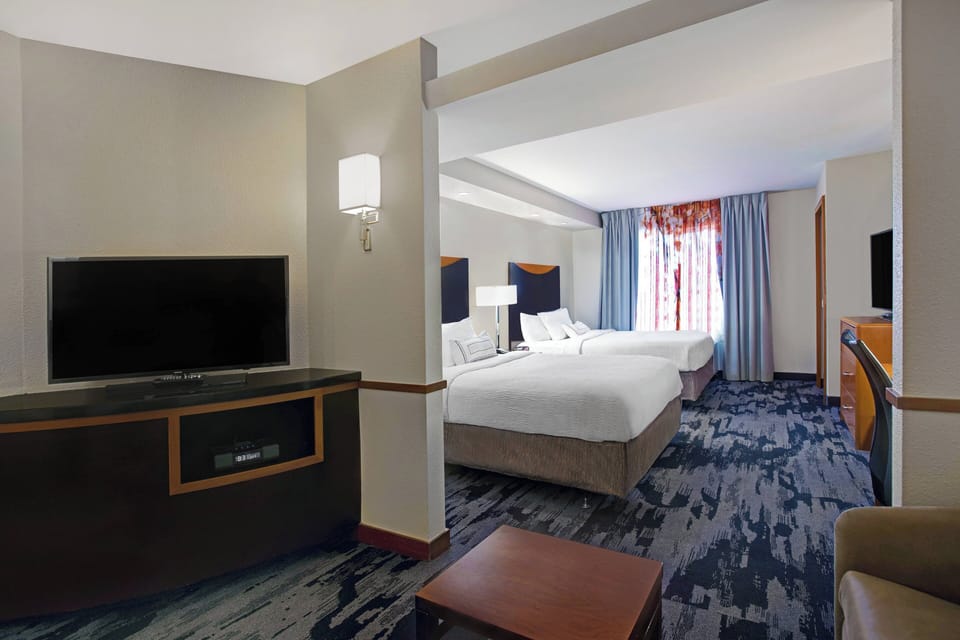 Premium bedding, desk, laptop workspace, blackout drapes