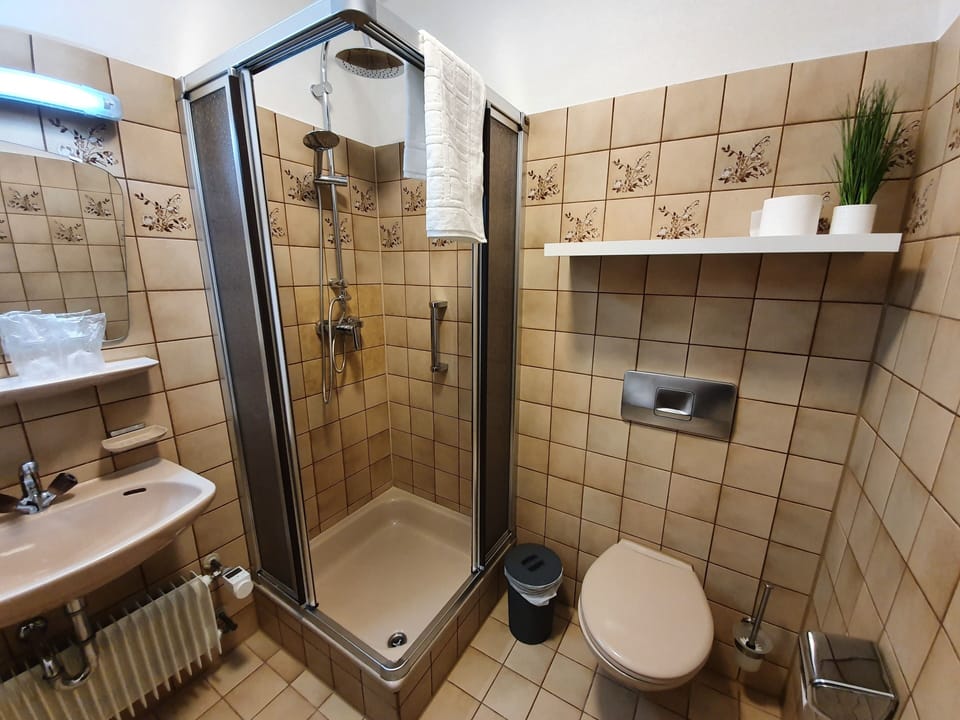 Shower, rainfall showerhead, hair dryer, towels