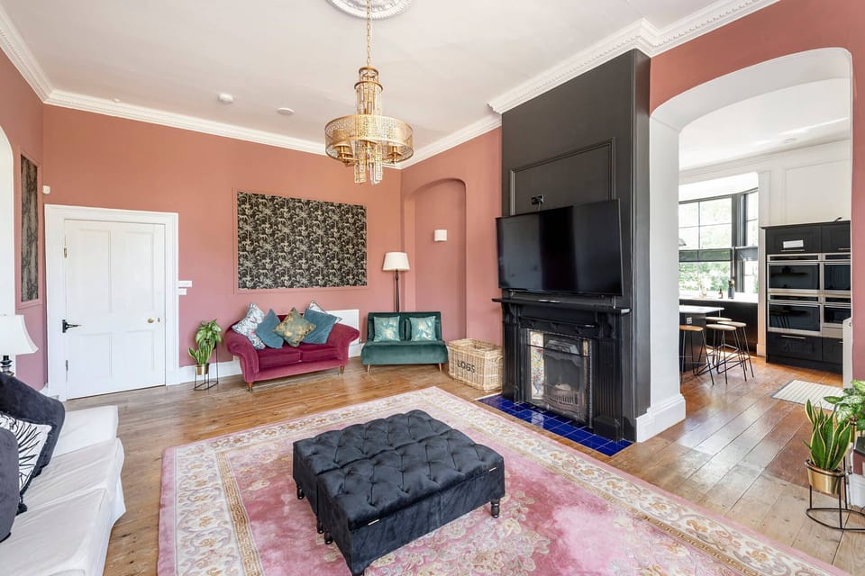 Ground floor: The living room has plenty of comfortable sofas, an open fire in a period fireplace and ornate cornicing