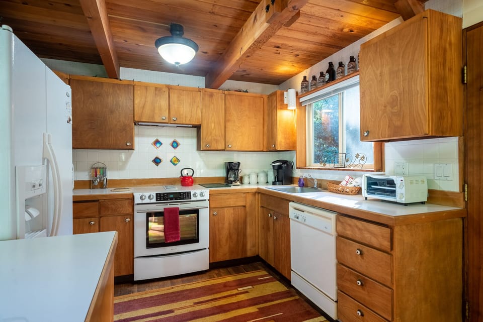 Kitchen, complete with microwave, refrigerator, oven, and dishwasher.