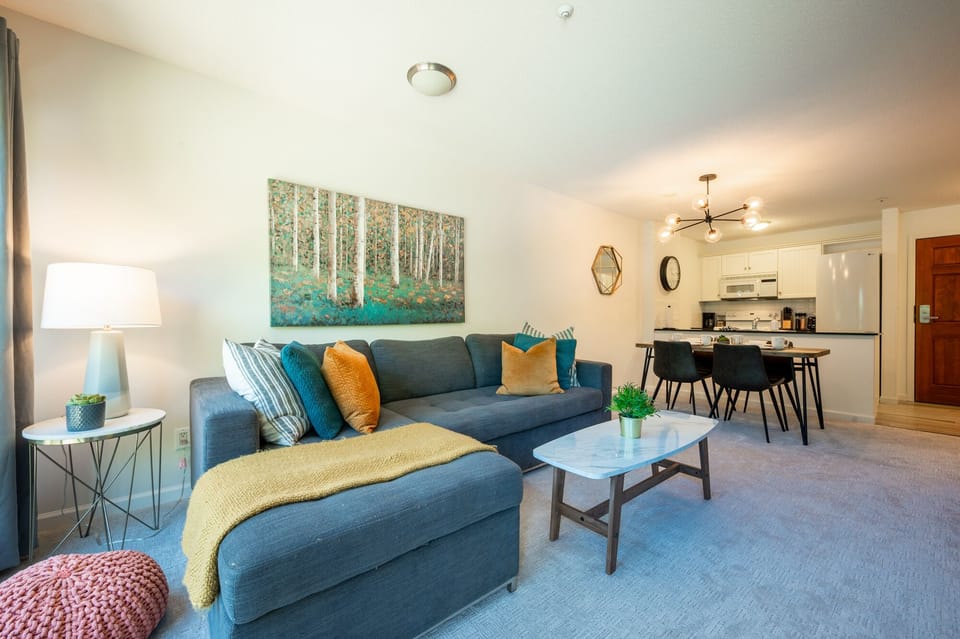 Living Room - Cozy up to the fireplace while you watch your favourite Netflix show on our super comfortable new couch.