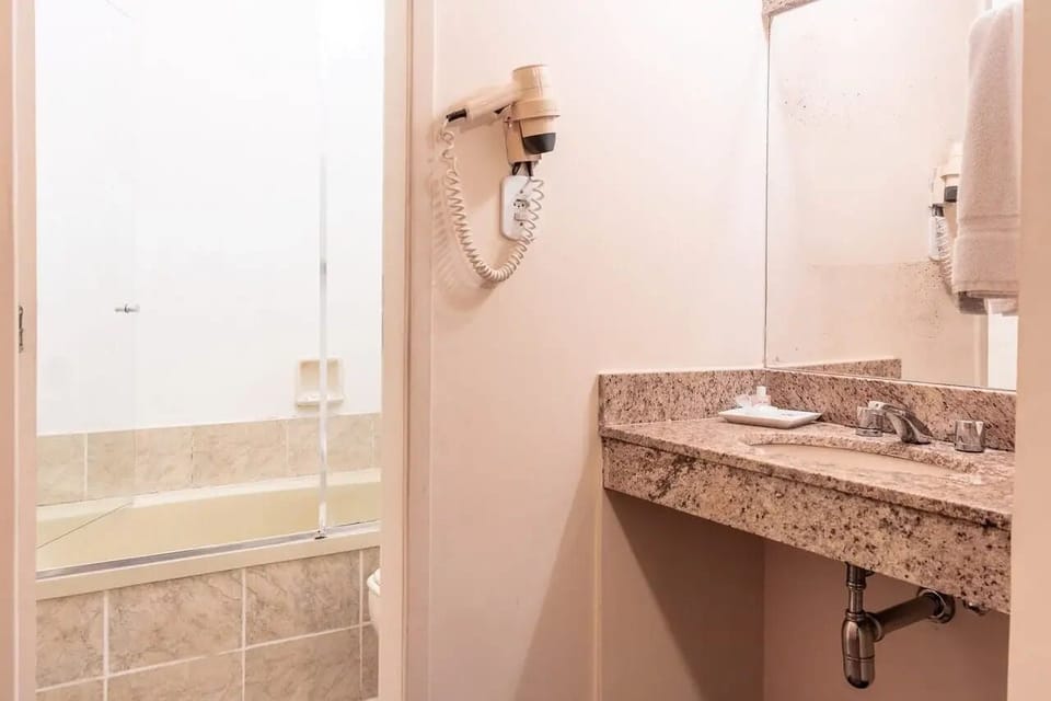 Shower, rainfall showerhead, hair dryer, towels