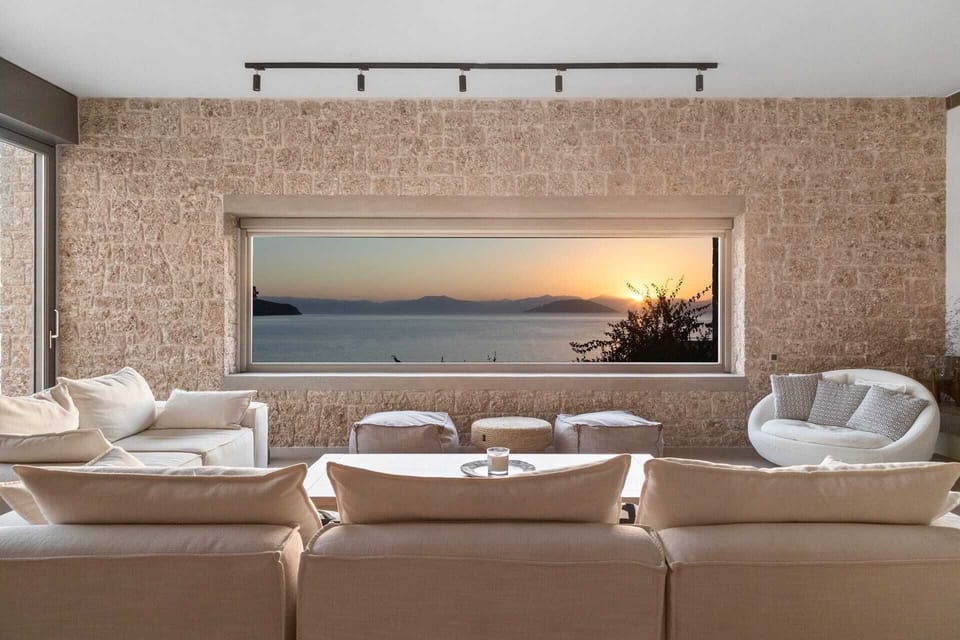 From the villa's living room, the sunset paints the sky in warm hues.