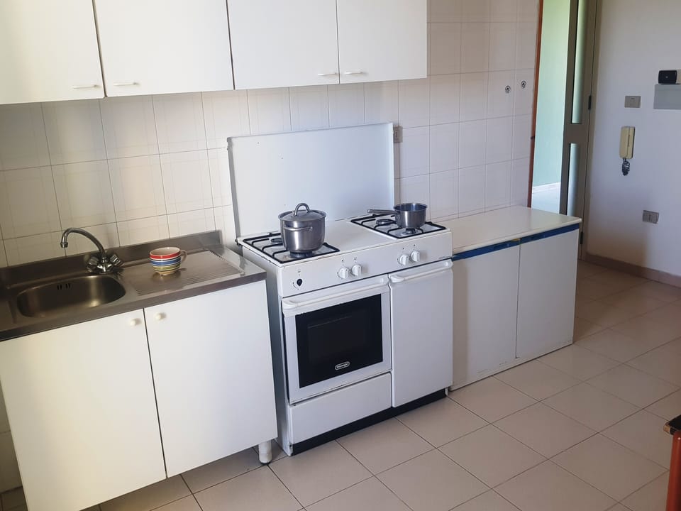 Apartment, 1 Bedroom (Bilocale Europa 90) | Private kitchen | Full-size fridge, oven, stovetop, cookware/dishes/utensils