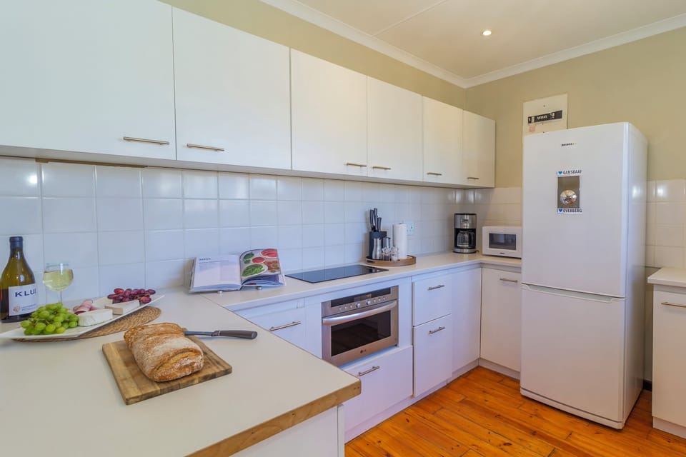 semi-open kitchen, microwave, oven, induction hob, large fridge and freezer