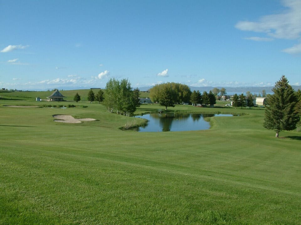 Tee off in paradise at Bear Lake Golf Course—lush greens, serene ponds, and wide-open views for golf lovers!