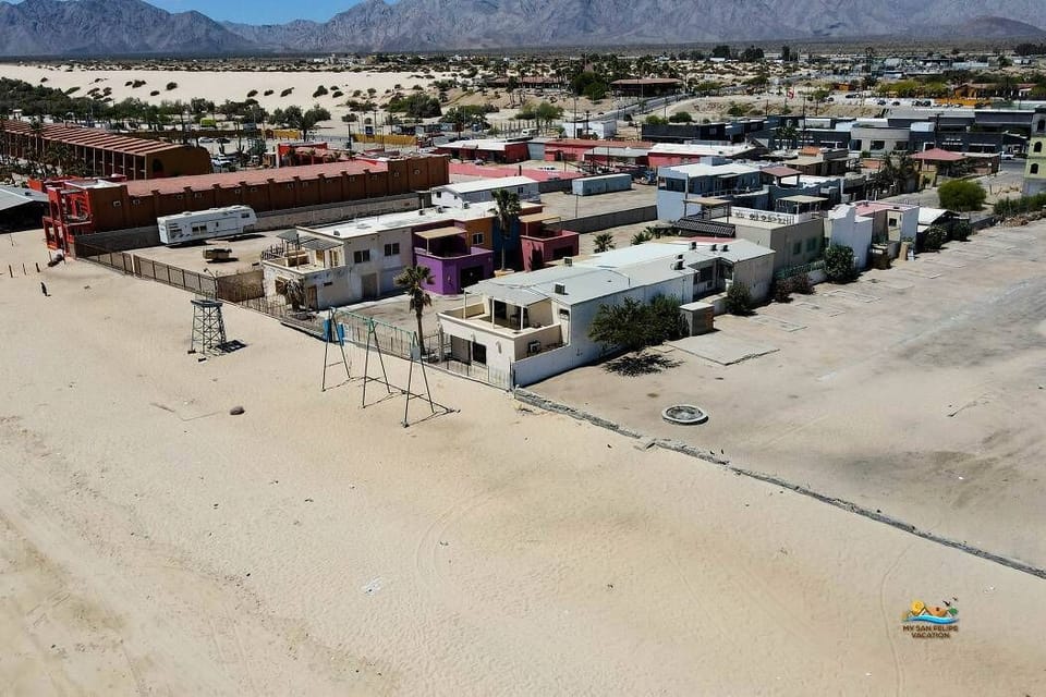 This aerial shot from the left side shows Casey's Condo 1 with the Sea of Cortez directly adjacent — including the private patio and a clear view of the beach .