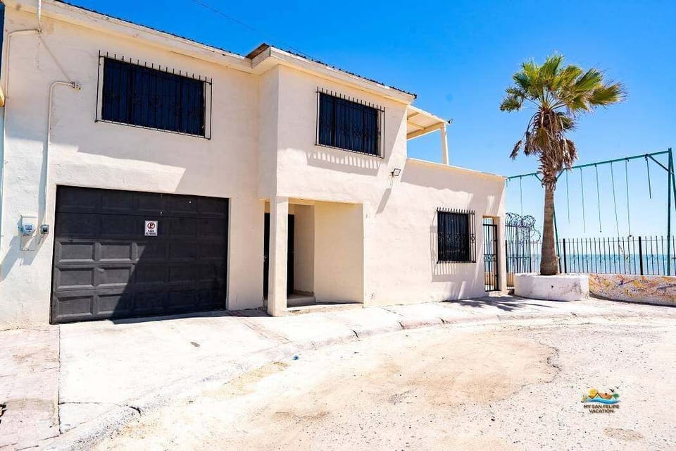 The left side of this beachfront condo features a private patio with BBQ and seating area — just steps from the sand and a short walk to the Malecon