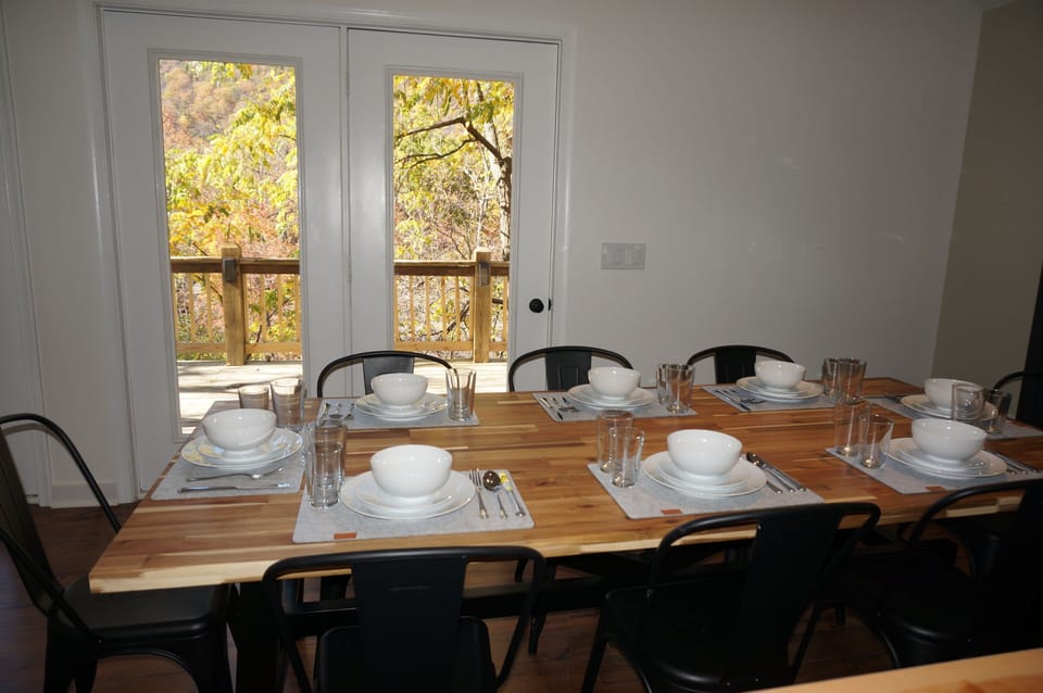 Large dining table with seating for ten including dinnerware and utensils