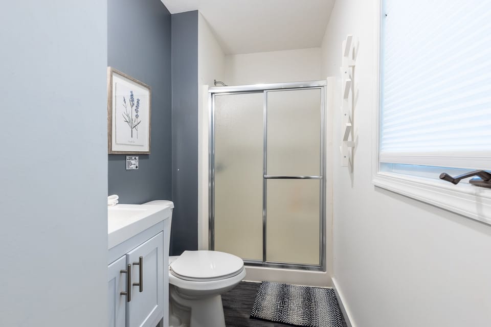 En suite master bath with shower. Fully stocked with soap and shampoo