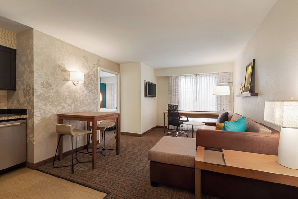 Premium bedding, desk, laptop workspace, blackout drapes