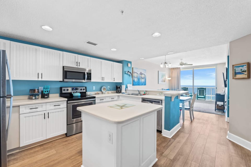 【Kitchen】 Fully stocked for group cooking — full-size fridge, stainless appliances, island seating.