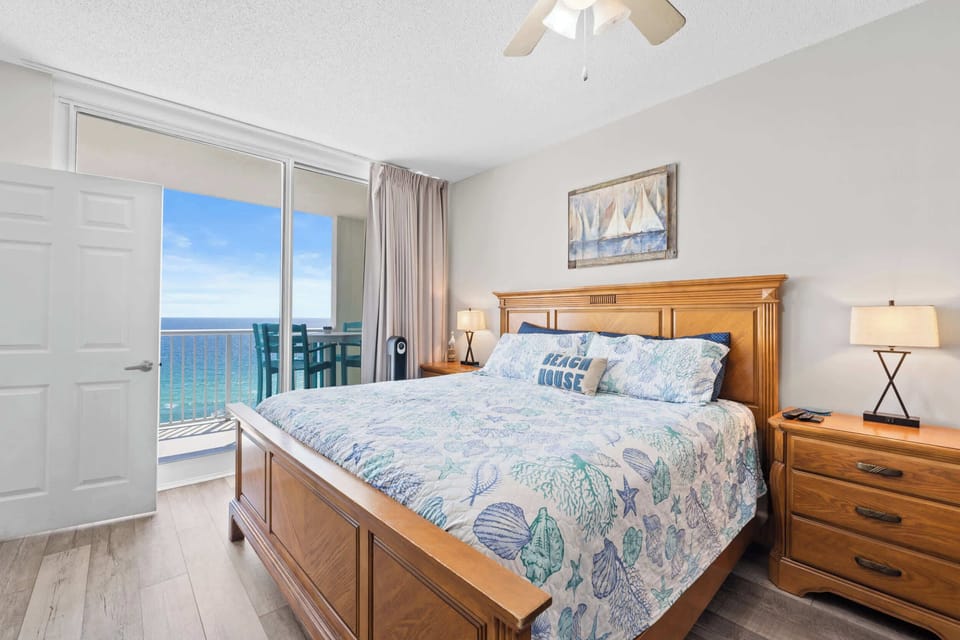 【Primary Bedroom】 King bed + private Gulf-view balcony access — largest of the 3 bedrooms.