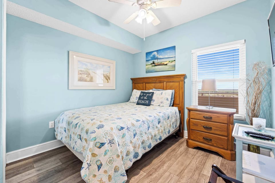 【Bedroom】 Wood headboard, floral quilt, white dresser — light, airy, and Gulf Coast calm.