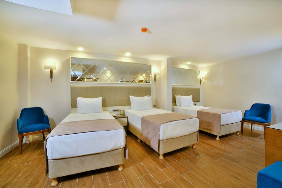 Standard Triple Room | Minibar, in-room safe, iron/ironing board, free WiFi