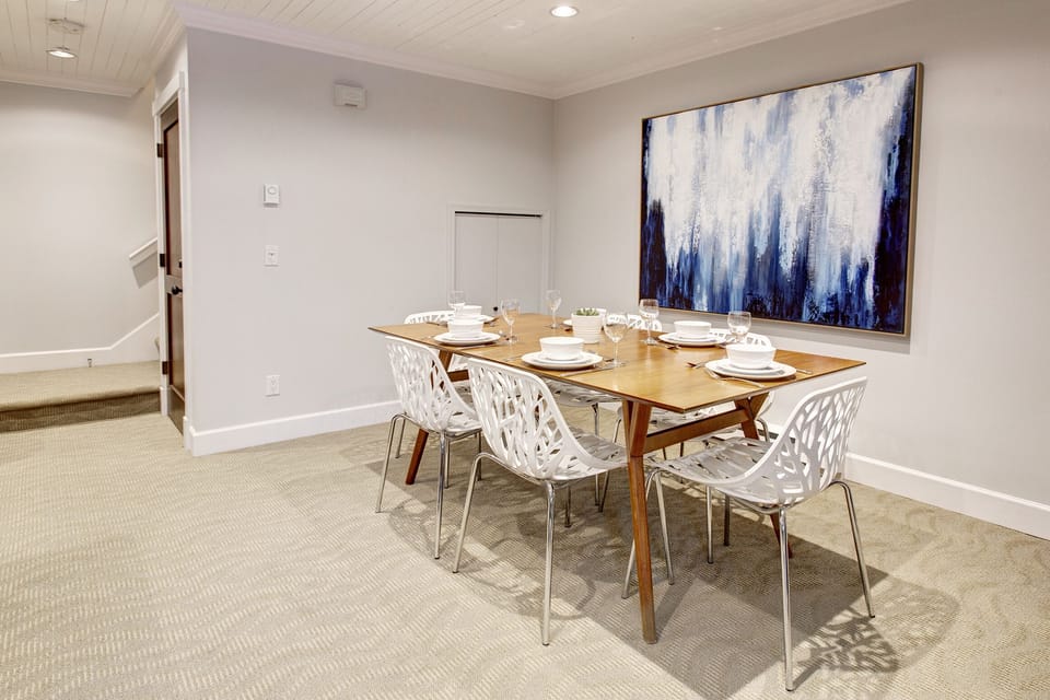 View from living room looking into dining area with comfortable seating for 7