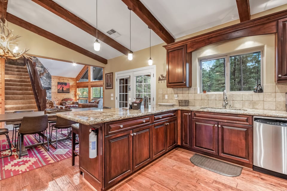 View of kitchen, dining area, great room and stairs to the loft. 
