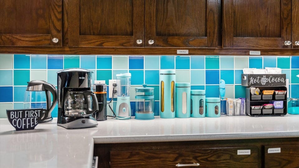 A well-stocked coffee and beverage station featuring a coffee maker, French press, and hot cocoa bar—perfect for starting your morning or unwinding with a warm drink in this beautifully designed kitchen.