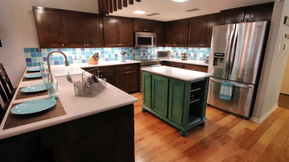 The kitchen is compact yet efficient, with a built-in trash can, island storage, and cabinets full of dishes and tools for all your needs. Thoughtfully designed to maximize space—just bring the food and enjoy!