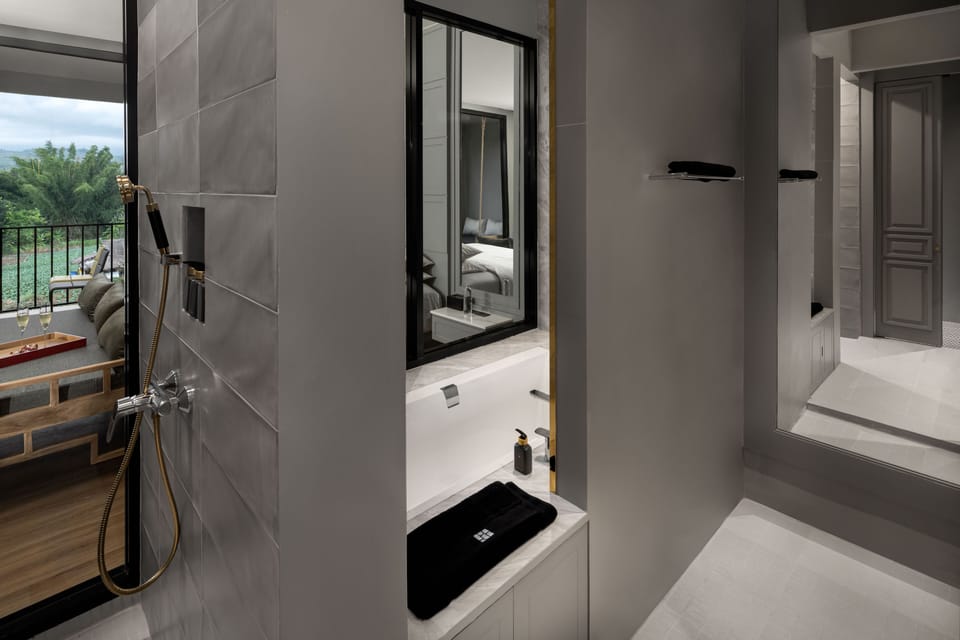 Separate tub and shower, rainfall showerhead, designer toiletries