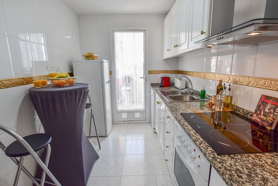 Kitchen bar table & stools for a quick breakfast. Washing machine fridge freezer