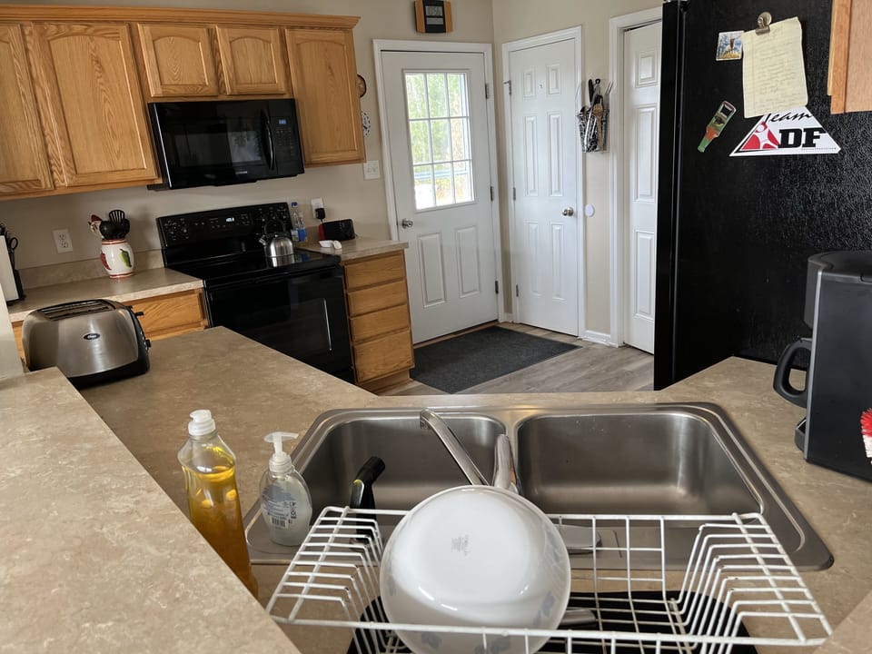 Kitchen has double sink, new fridge and dishwasher, stove and microwave.