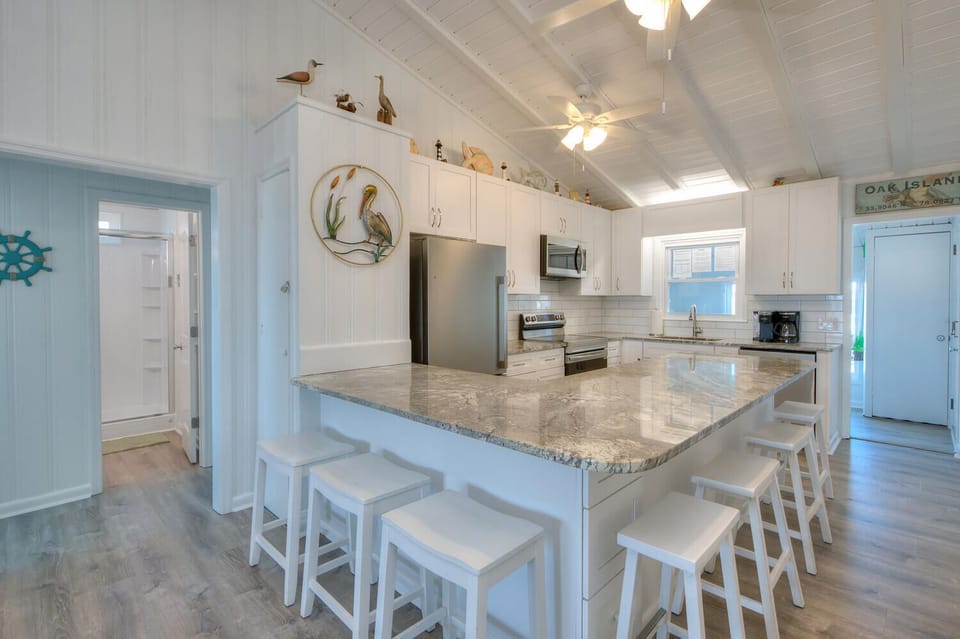Kitchen with peninsula/dining combo with seating for 7-8 people.
