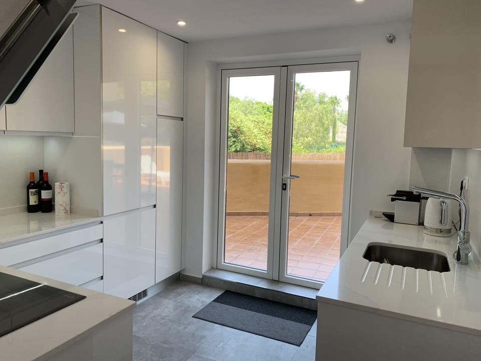 New kitchen - patio doors leading out to upper rear terrace