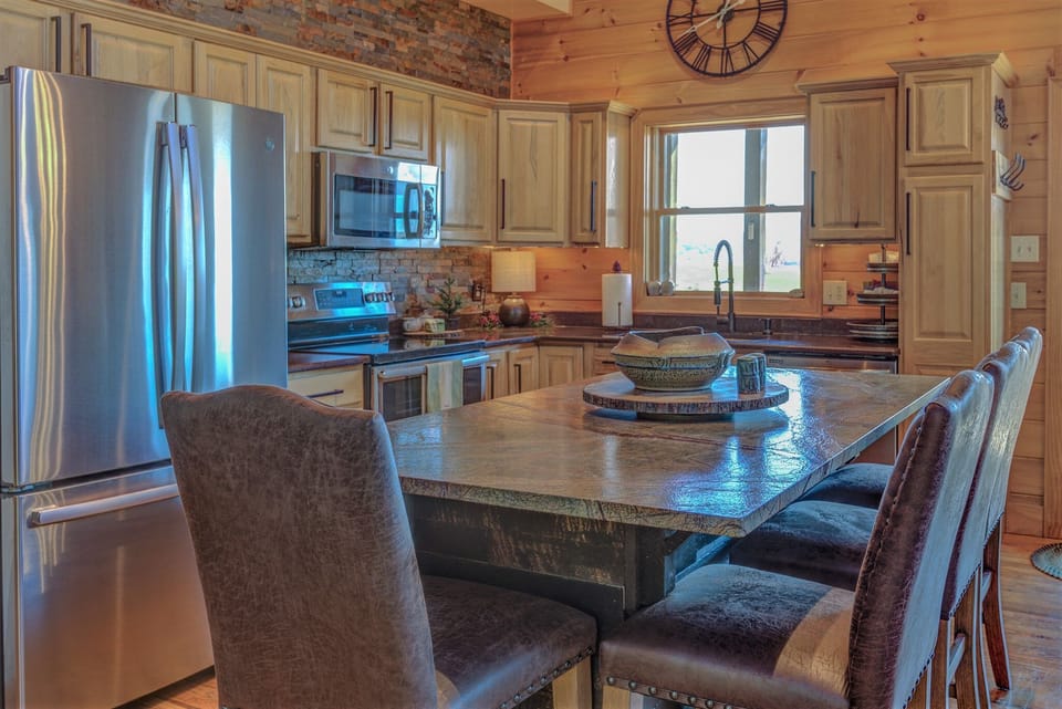 Large, fully stocked kitchen with double oven. Island seating for four people