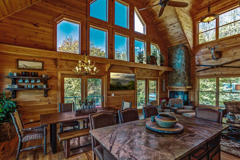 Kitchen open to interaction with guests, TV, and fireplace