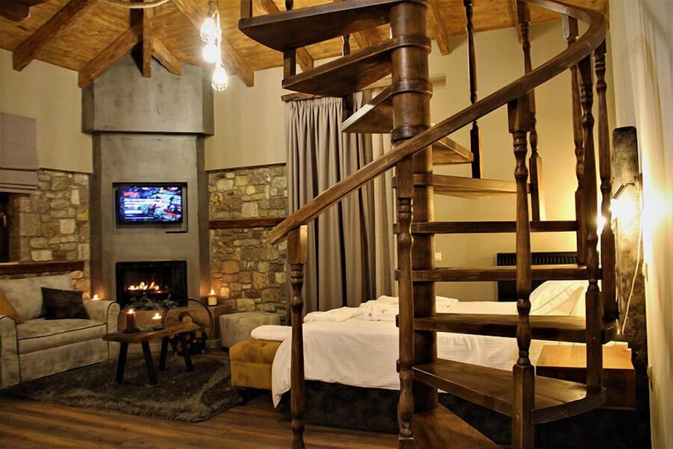 Luxury Suite | Living area | 40-inch LCD TV with satellite channels, TV, fireplace