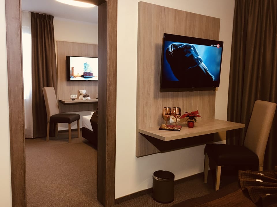 Family Quadruple Room | Living area | Flat-screen TV
