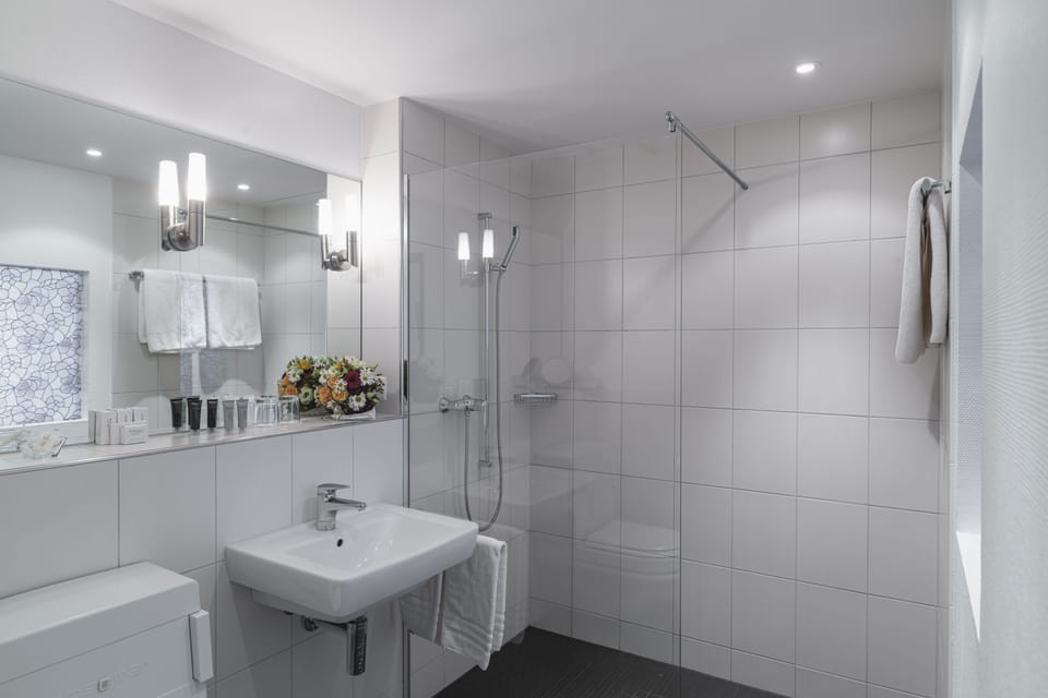 Shower, hair dryer, slippers, towels